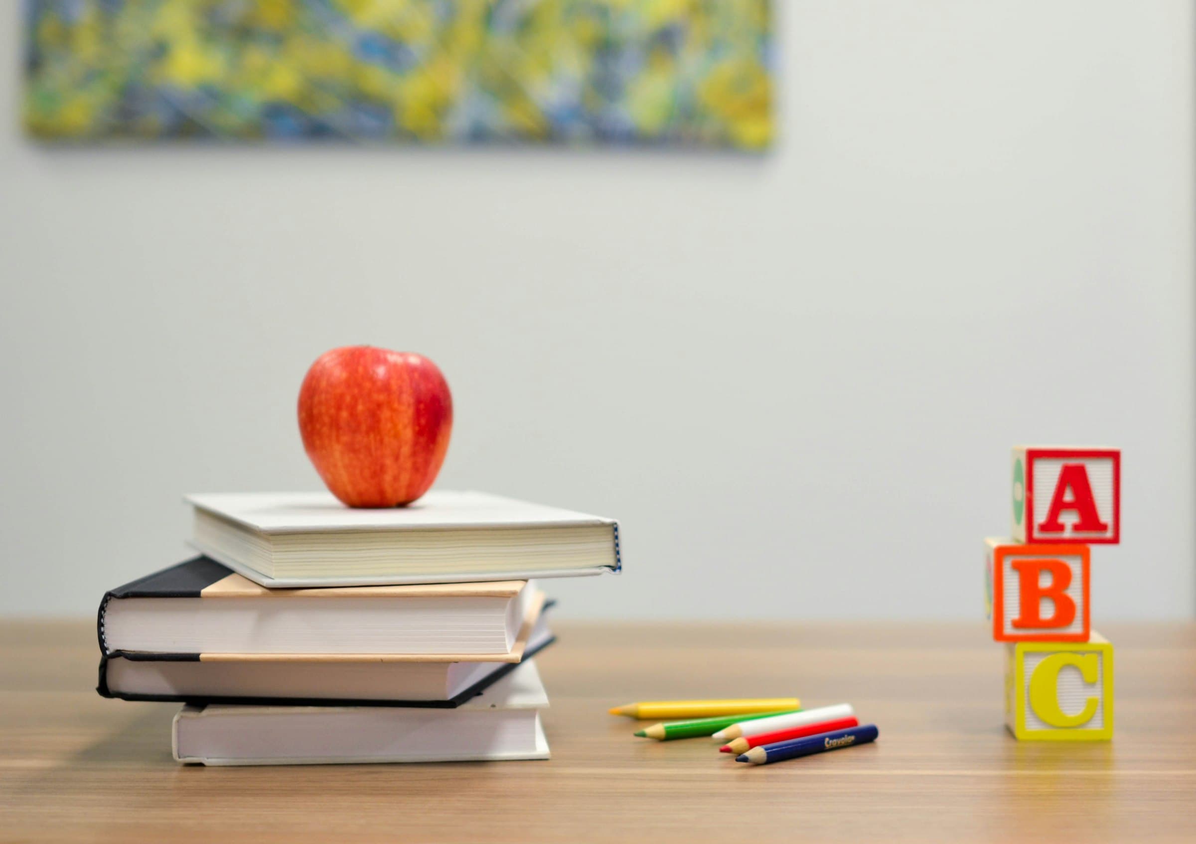 Books, apple and ABC blocks symbolising admission enquiry at Doon International School